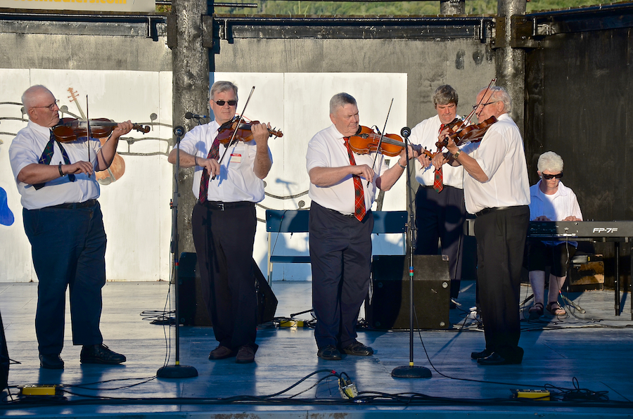 The original members of the Glengarry Strathspey and Reel Society accompanied by Catherine Olive DeFreitas