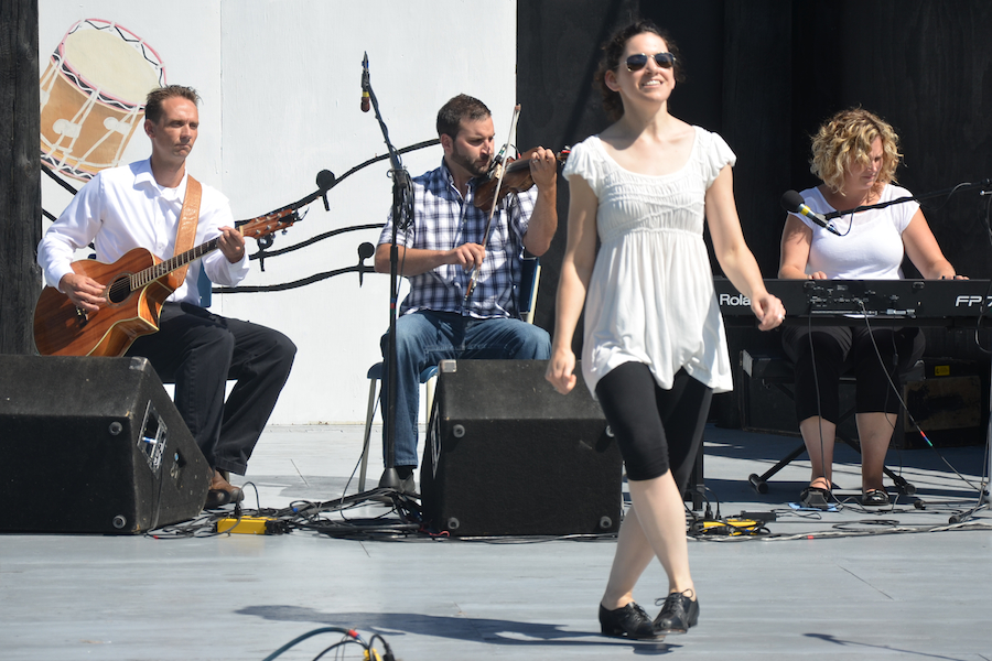 Lisa Gallant-MacNeil step‑dancing to the music of Brent Aucoin on fiddle, Leanne Aucoin on keyboard, and Jesse Lewis on guitar