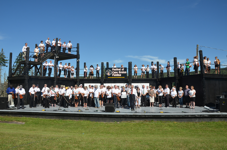 Father Frances Cameron leads the tribute prayer as the Cape Breton Fiddlers’ Association listen
