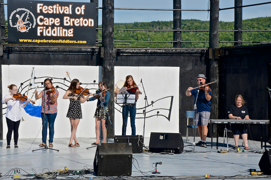 Kyle MacNeil with five of his students on fiddle accompanied by Susan MacLean on keyboard