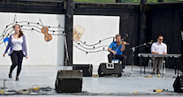 Natalie DeCoste step‑dancing to the music of Rodney MacDonald on fiddle and Kolten MacDonell on keyboard