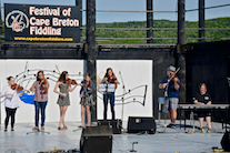 Kyle MacNeil with five of his students on fiddle accompanied by Susan MacLean on keyboard