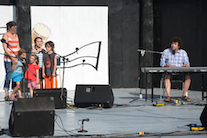 The Gallant family sings a song accompanied by Gary Gallant on keyboard