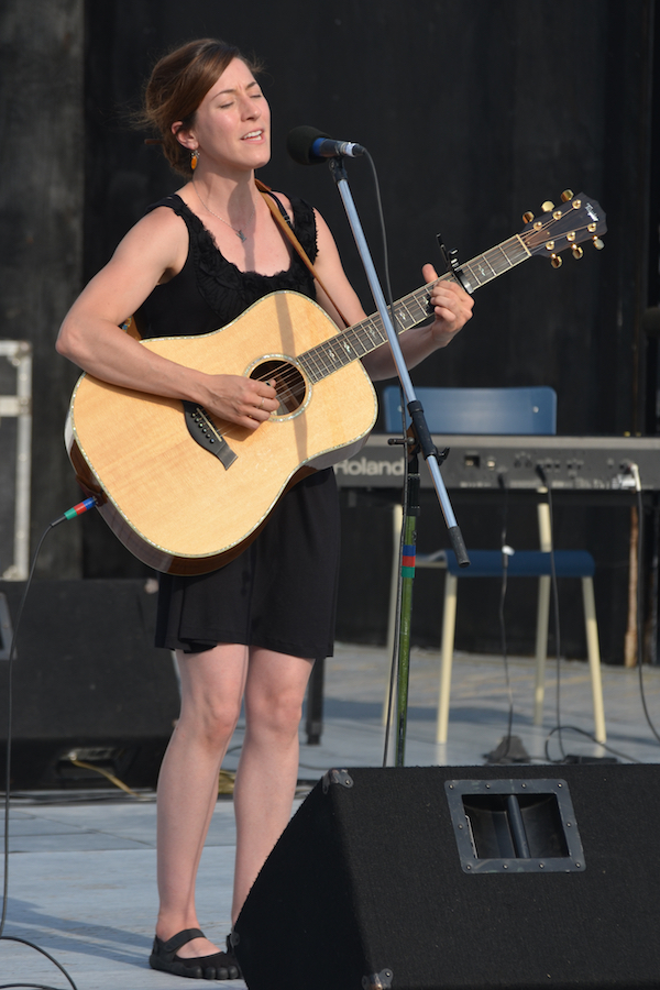 Erin Martell singing to her own guitar accompaniment