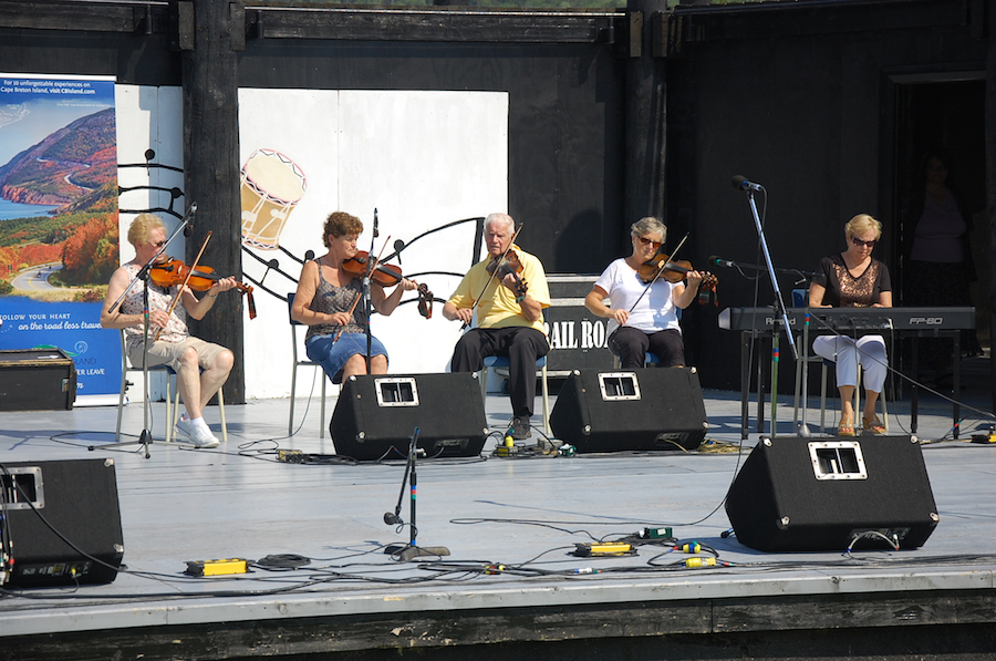 Lorraine Lynch, Marlene Gallant, Father Charlie Cheverie, and Linda Jensen-Moran on fiddles, accompanied by Betty Lou Beaton on keyboard