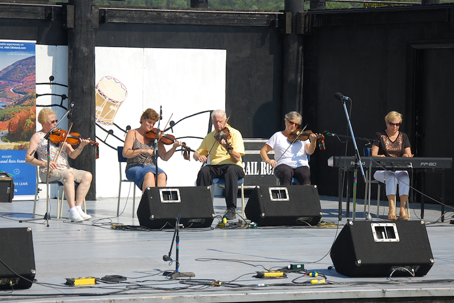Lorraine Lynch, Marlene Gallant, Father Charlie Cheverie, and Linda Jensen-Moran on fiddles, accompanied by Betty Lou Beaton on keyboard