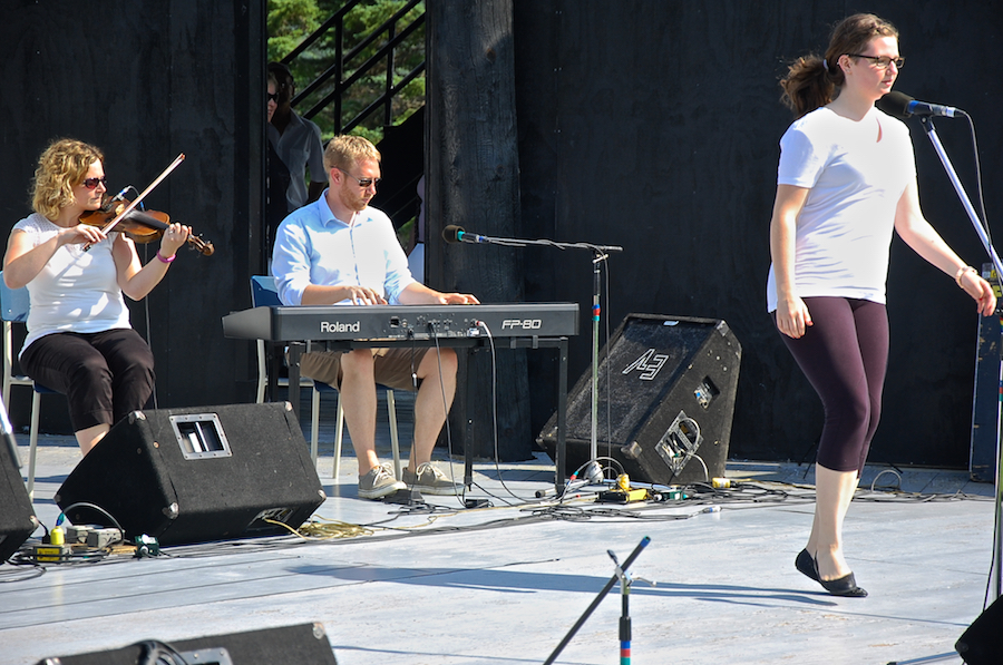 Kayla Marchand step‑dancing to the music of Leanne Aucoin on fiddle and Adam Young on keyboard