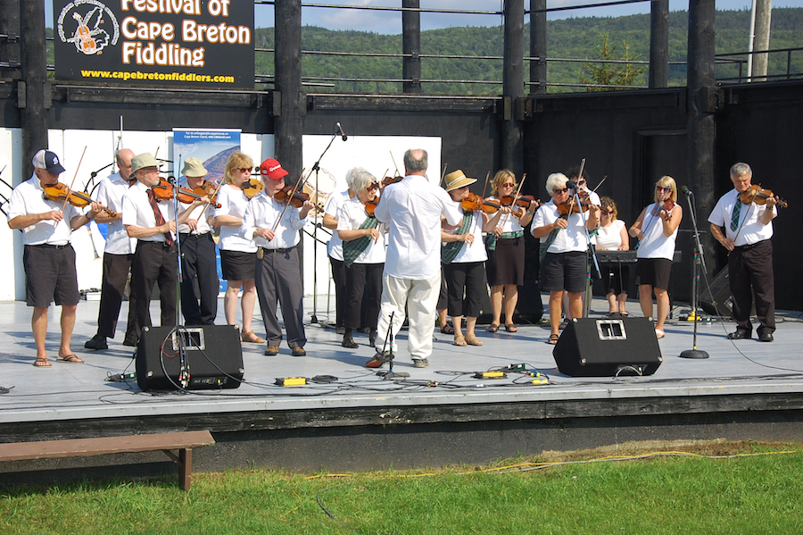 The Feisty Fiddlers— The Cape Breton University Seniors Fiddling Group, directed by Eddie Rogers and accompanied by Leanne Aucoin on keyboard