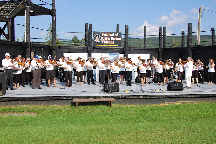 The Cape Breton Fiddlers’ Association plays a set in tribute, directed by Eddie Rogers and accompanied by Betty Lou Beaton on keyboard