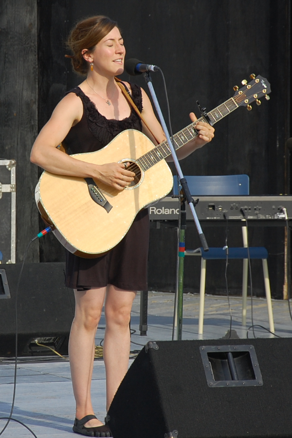 Erin Martell singing to her own guitar accompaniment