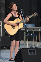 Erin Martell singing to her own guitar accompaniment