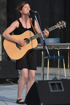 Erin Martell singing to her own guitar accompaniment
