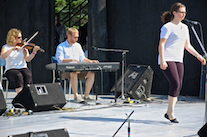 Kayla Marchand step‑dancing to the music of Leanne Aucoin on fiddle and Adam Young on keyboard
