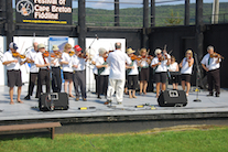 The Feisty Fiddlers— The Cape Breton University Seniors Fiddling Group, directed by Eddie Rogers and accompanied by Leanne Aucoin on keyboard