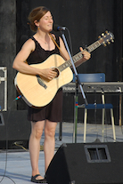 Erin Martell singing to her own guitar accompaniment