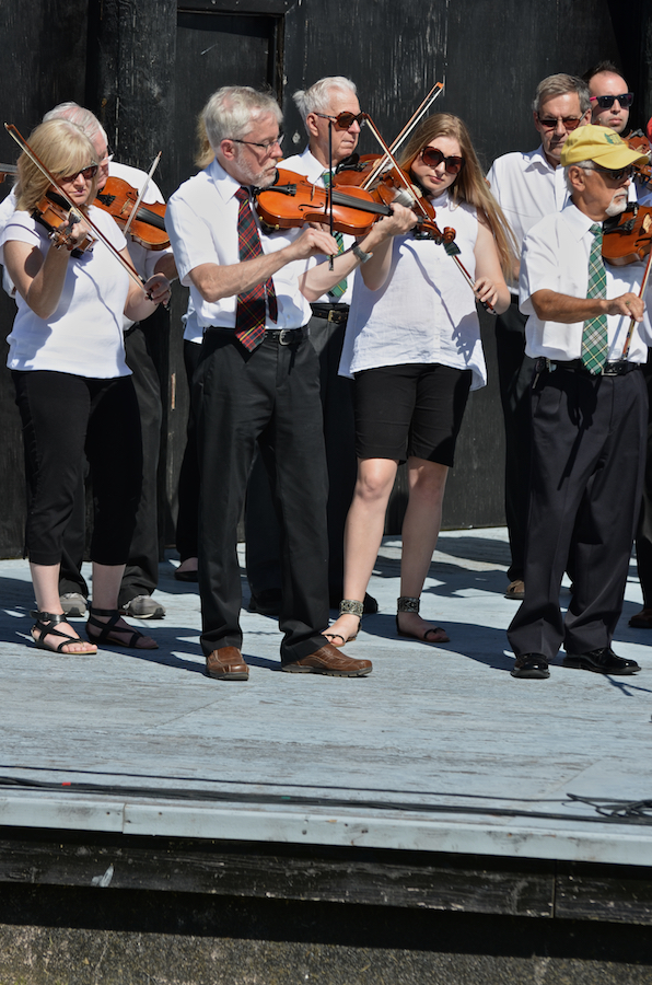 The Cape Breton Fiddlers’ Association plays its second group number in tribute
