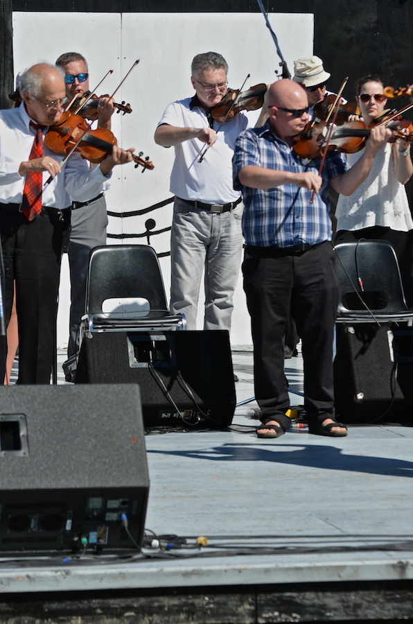 The Cape Breton Fiddlers’ Association plays its second group number in tribute