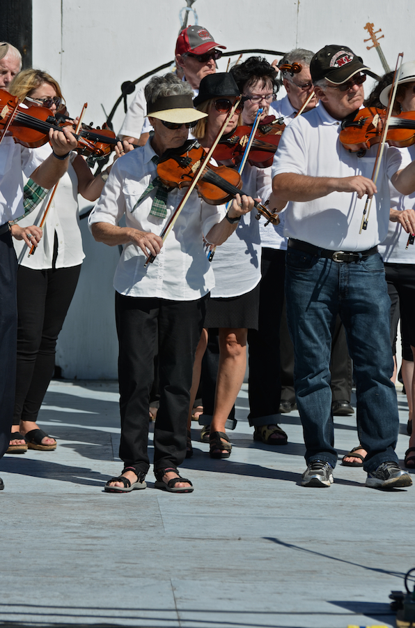 The Cape Breton Fiddlers’ Association plays its second group number in tribute