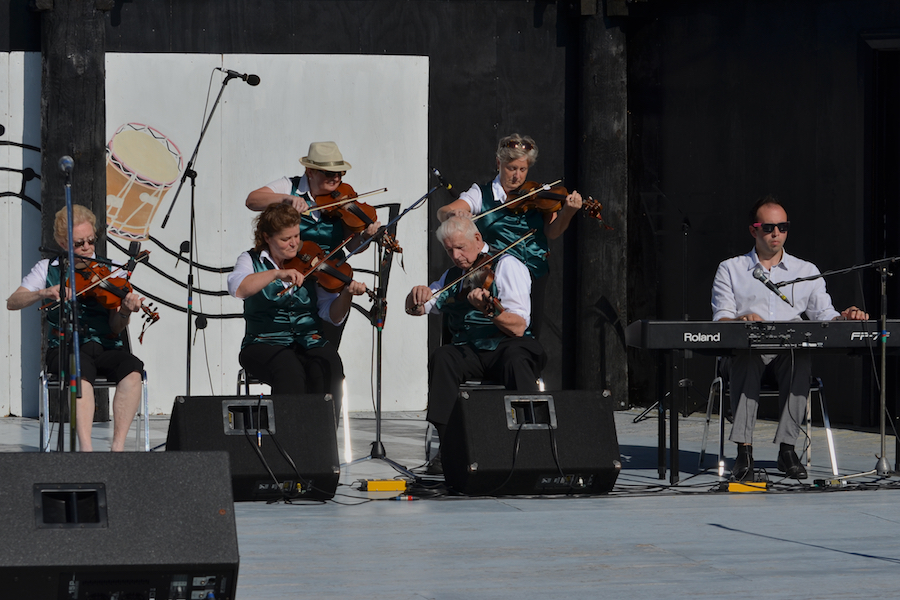 A contingent of the PEI Queens County Fiddlers accompanied by Kolten MacDonell on keyboard