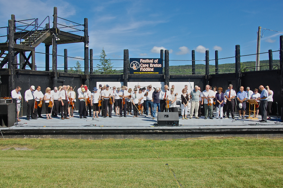 Fr Francis Cameron offers the opening prayer as the Cape Breton Fiddlers’ Association members stand in silent recollection