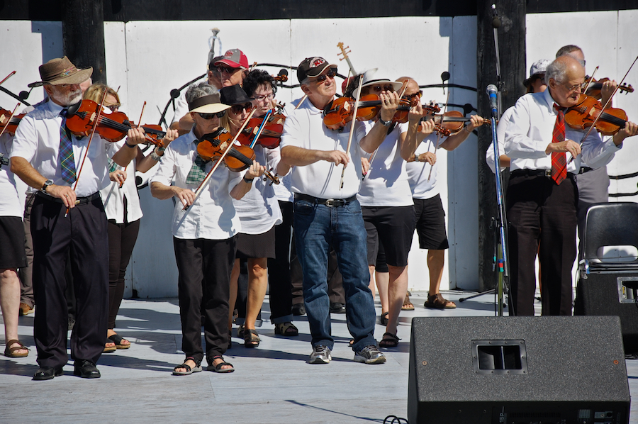 The Cape Breton Fiddlers’ Association plays its second group number in tribute