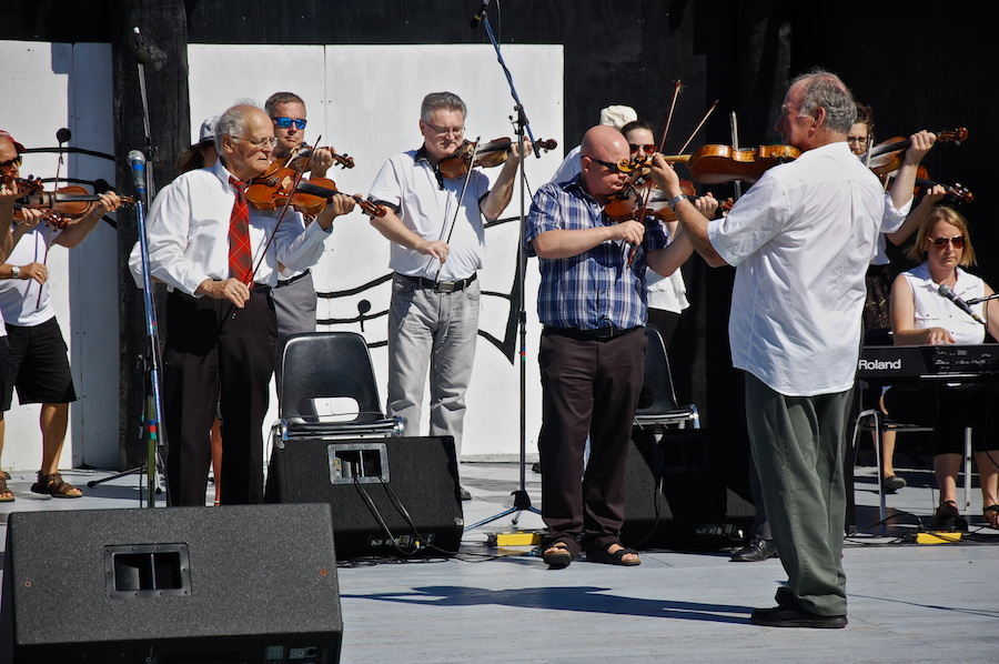 The Cape Breton Fiddlers’ Association plays its second group number in tribute