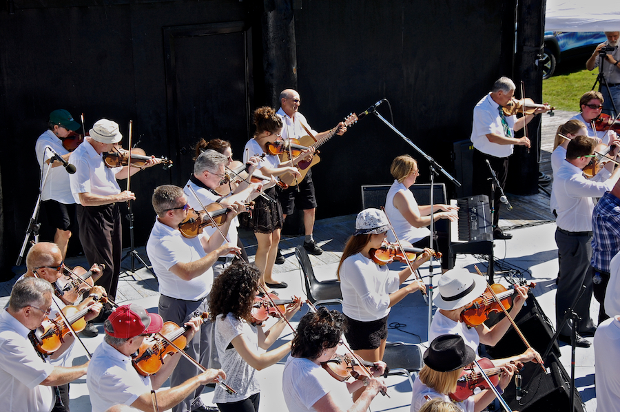 The Cape Breton Fiddlers’ Association plays its second group number in tribute