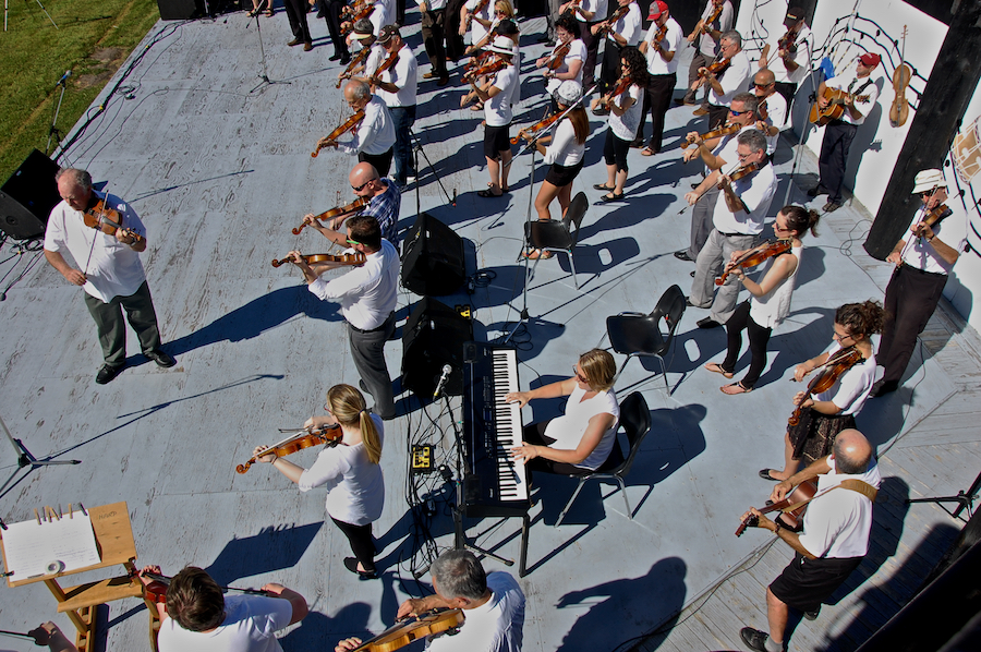 The Cape Breton Fiddlers’ Association plays its second group number in tribute