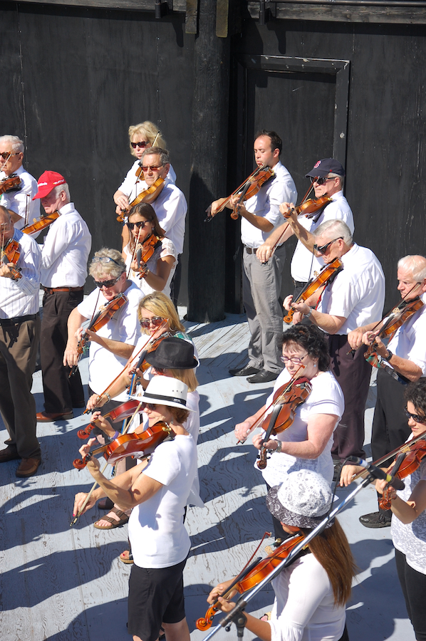 The Cape Breton Fiddlers’ Association plays its second group number in tribute