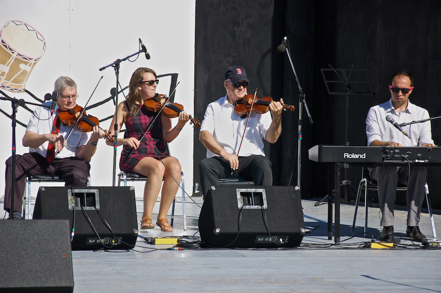Don MacPhee, Koryne Fraser, and Bernard MacDonnell on triple fiddles accompanied by Kolten MacDonell on keyboard