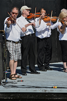 The Cape Breton Fiddlers’ Association plays its second group number in tribute