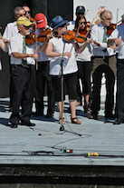The Cape Breton Fiddlers’ Association plays its second group number in tribute