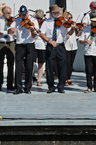 The Cape Breton Fiddlers’ Association plays its second group number in tribute