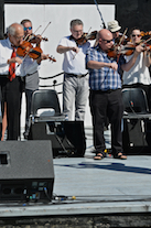 The Cape Breton Fiddlers’ Association plays its second group number in tribute
