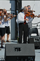 The Cape Breton Fiddlers’ Association plays its second group number in tribute