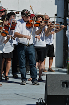 The Cape Breton Fiddlers’ Association plays its second group number in tribute