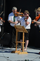 The Cape Breton Fiddlers’ Association plays its second group number in tribute