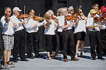 The Cape Breton Fiddlers’ Association plays its second group number in tribute