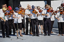 The Cape Breton Fiddlers’ Association plays its second group number in tribute