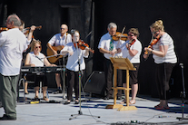 The Cape Breton Fiddlers’ Association plays its second group number in tribute