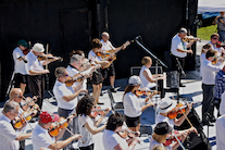 The Cape Breton Fiddlers’ Association plays its second group number in tribute