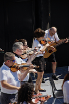 The Cape Breton Fiddlers’ Association plays its second group number in tribute