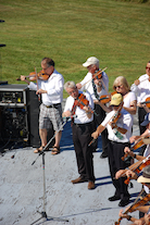 The Cape Breton Fiddlers’ Association plays its second group number in tribute