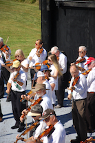The Cape Breton Fiddlers’ Association plays its second group number in tribute