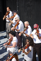 The Cape Breton Fiddlers’ Association plays its second group number in tribute