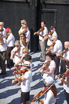 The Cape Breton Fiddlers’ Association plays its second group number in tribute