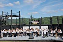The Cape Breton Fiddlers’ Association plays its second group number in tribute, directed by Eddie Rogers and accompanied by Susan MacLean on keyboard