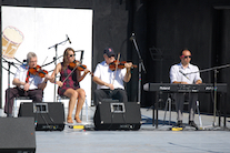 Don MacPhee, Koryne Fraser, and Bernard MacDonnell on triple fiddles accompanied by Kolten MacDonell on keyboard