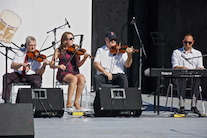 Don MacPhee, Koryne Fraser, and Bernard MacDonnell on triple fiddles accompanied by Kolten MacDonell on keyboard
