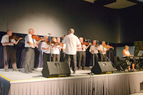 The Feisty Fiddlers directed by Eddie Rogers and accompanied by Carol Ann MacDougall on keyboard